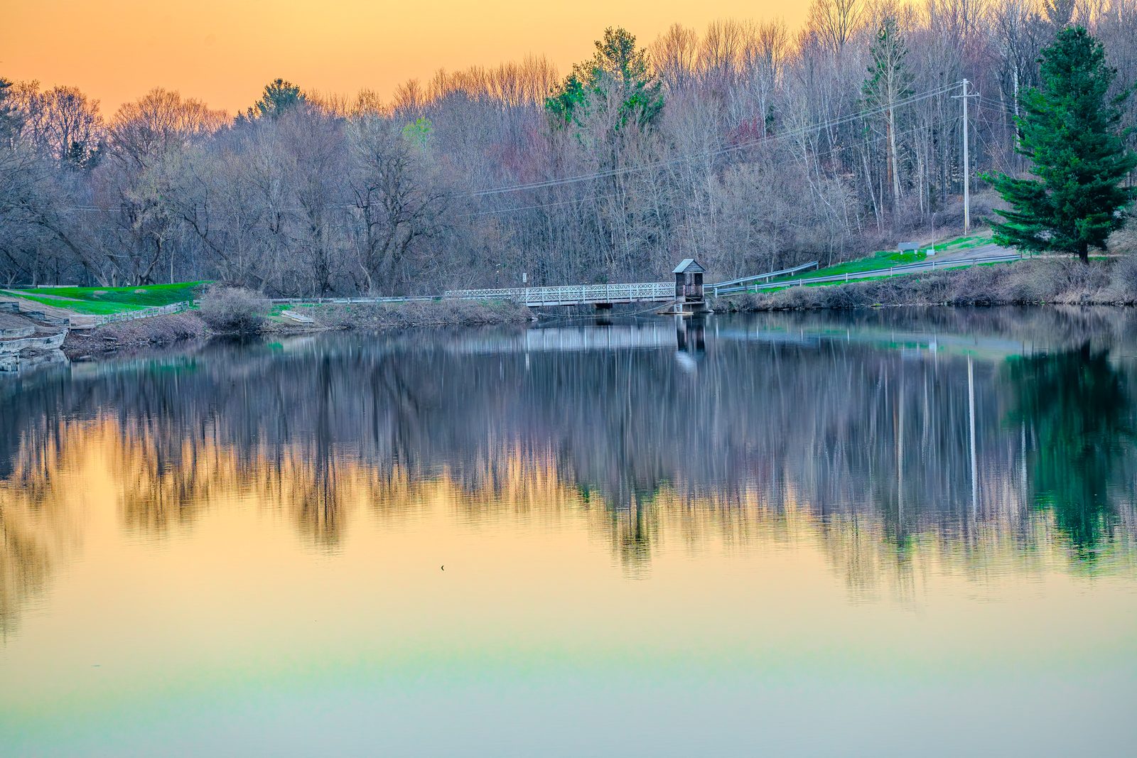 Adirondack pond at sunset, footbridge — Titus listing by Apex Pack Media