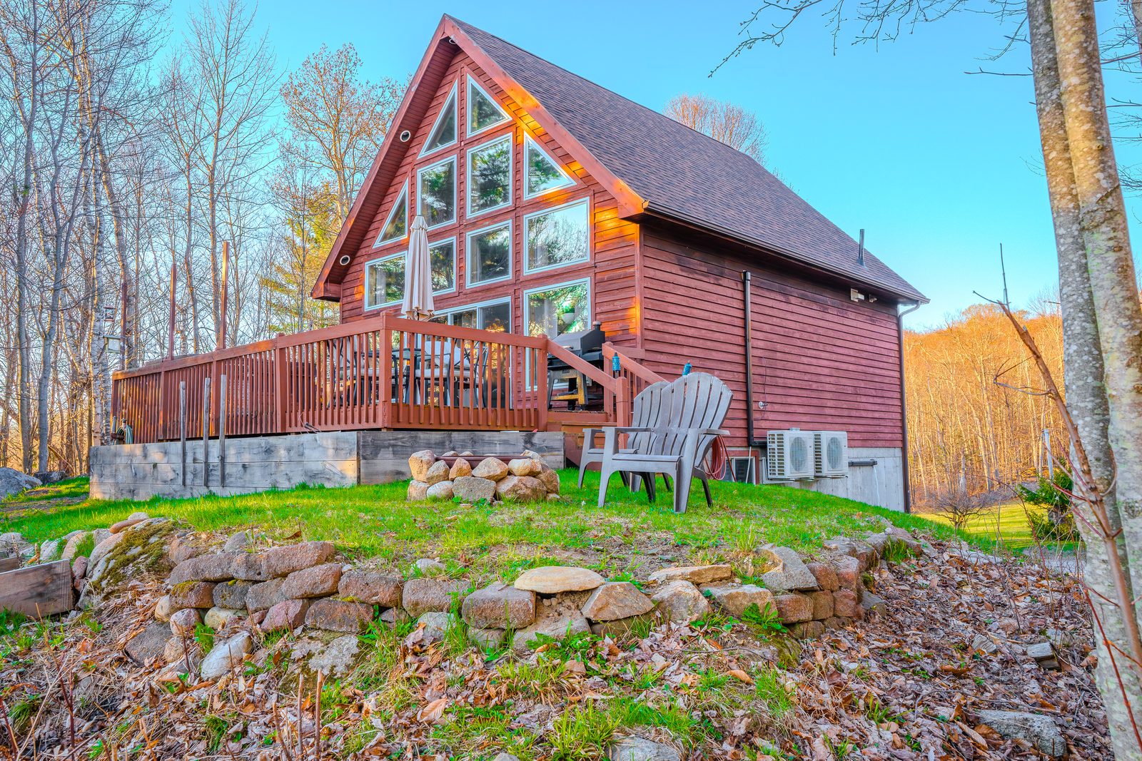 A-frame cabin with deck and Adirondack chair