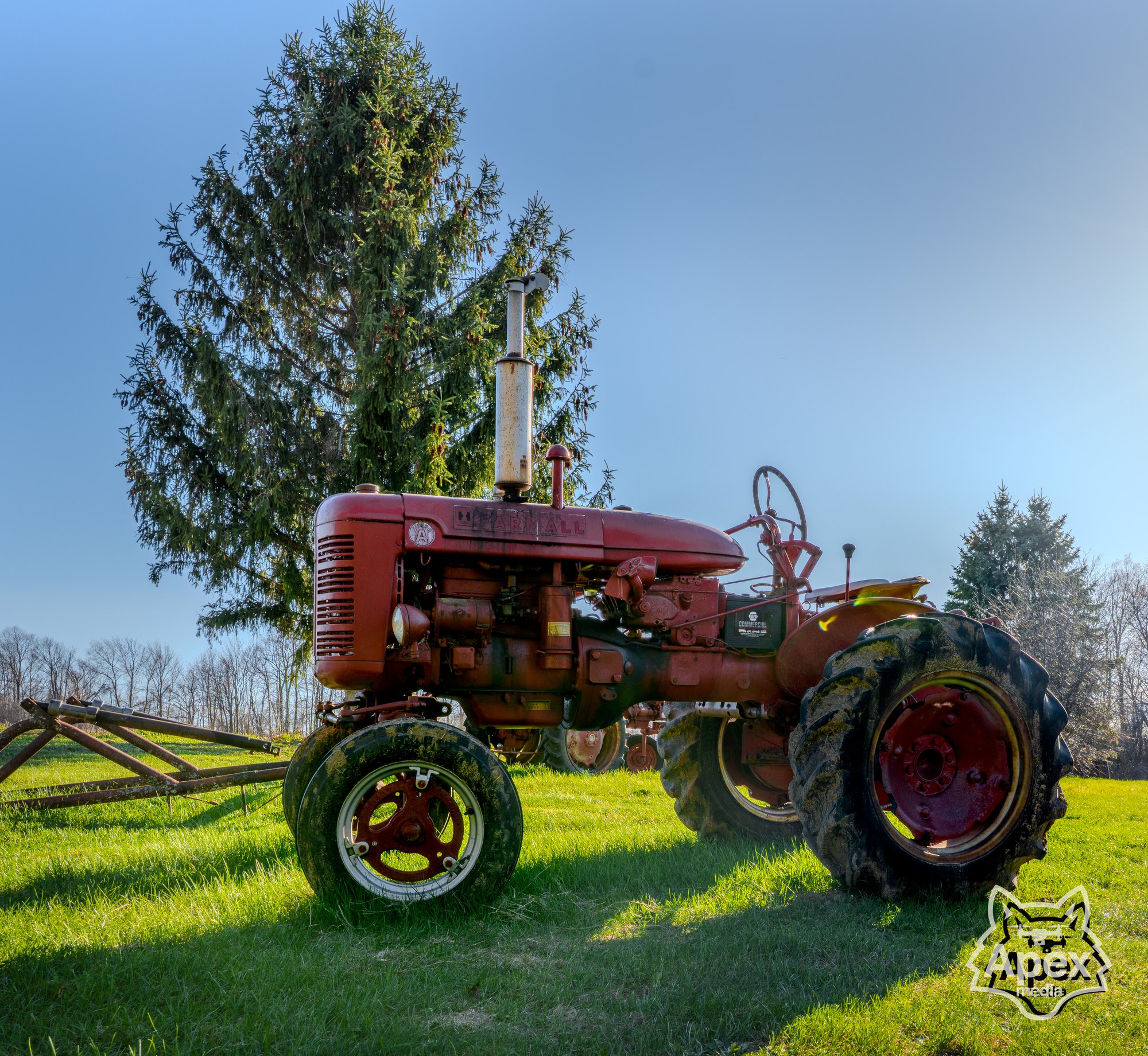 Red Farmall tractor in morning field, North Country